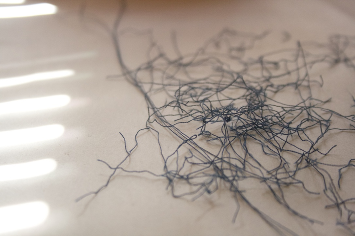 Tangled dark threads on light surface